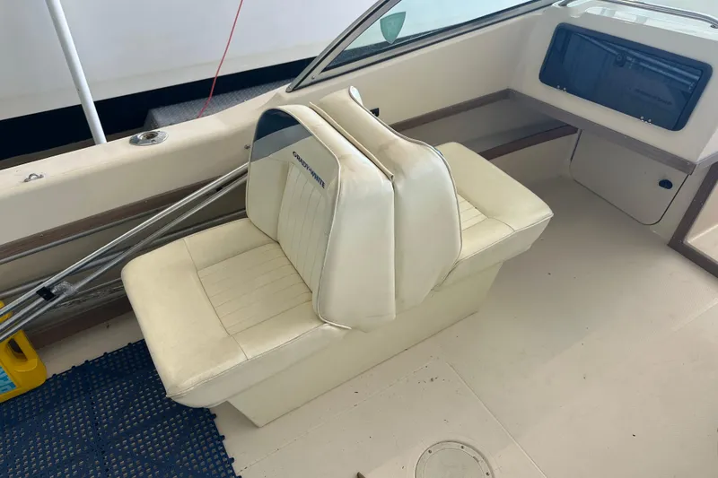 Slide: The Image of 1995 Grady-White Tournament 192 boat interior with white seating and storage compartment. - 34