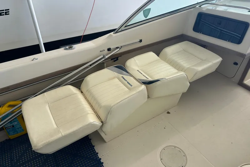 Slide: The Image of 1995 Grady-White Tournament 192 boat interior with white cushioned seats and storage area. - 35