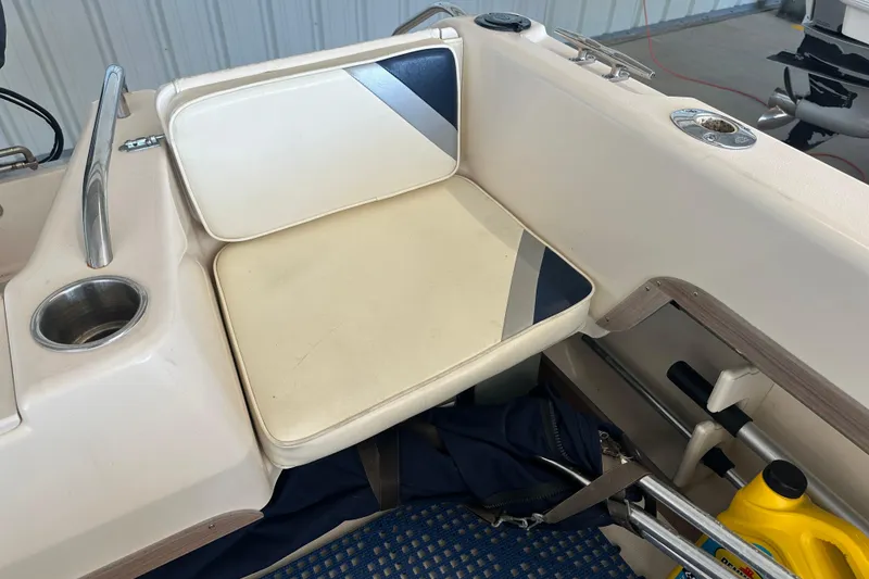 Slide: The Image of 1995 Grady-White Tournament 192 boat seat with cup holder and storage area. - 38