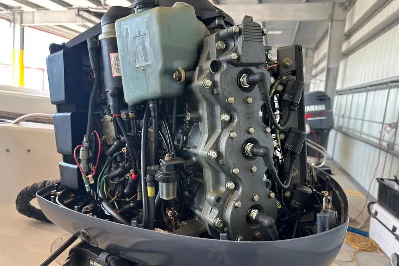 Slide: The Image of 1995 Grady-White Tournament 192 boat engine, detailed view in a garage setting. - 44