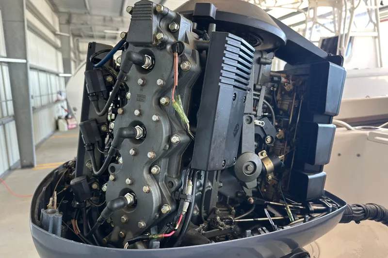 Slide: The Image of 1995 Grady-White Tournament 192 boat engine, detailed view in a garage setting. - 45