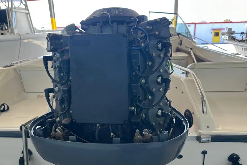 Slide: The Image of 1995 Grady-White Tournament 192 boat engine close-up in a marina setting. - 46