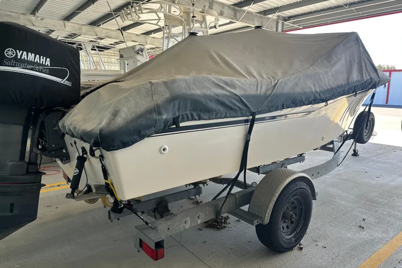 Slide: The Image of 1995 Grady-White Tournament 192 boat on trailer, covered, with Yamaha outboard motor. - 8