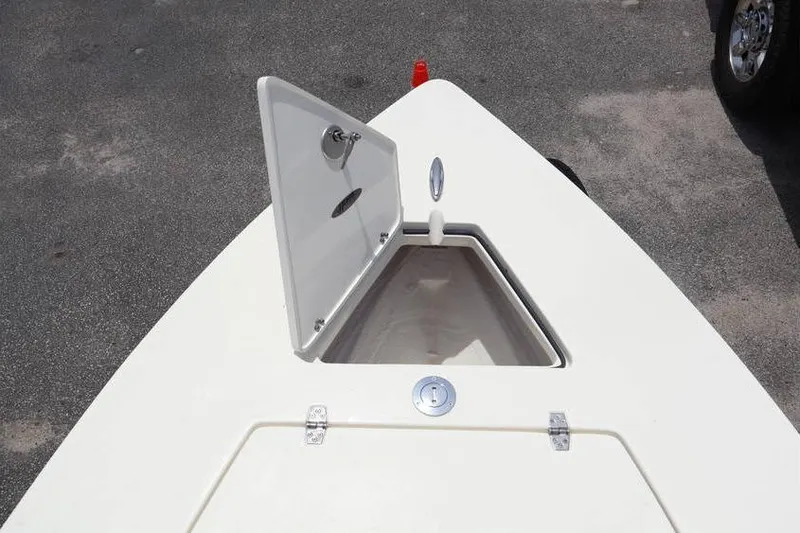 Slide: The Image of Open storage compartment on 2025 Hewes Redfisher 18 boat, showcasing interior wiring. - 4