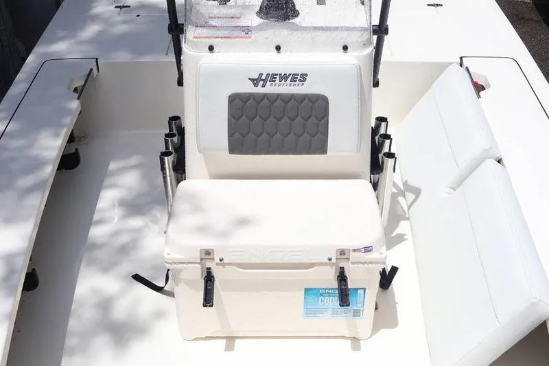 Slide: The Image of 2025 Hewes Redfisher 18 boat console with steering wheel and controls. - 9