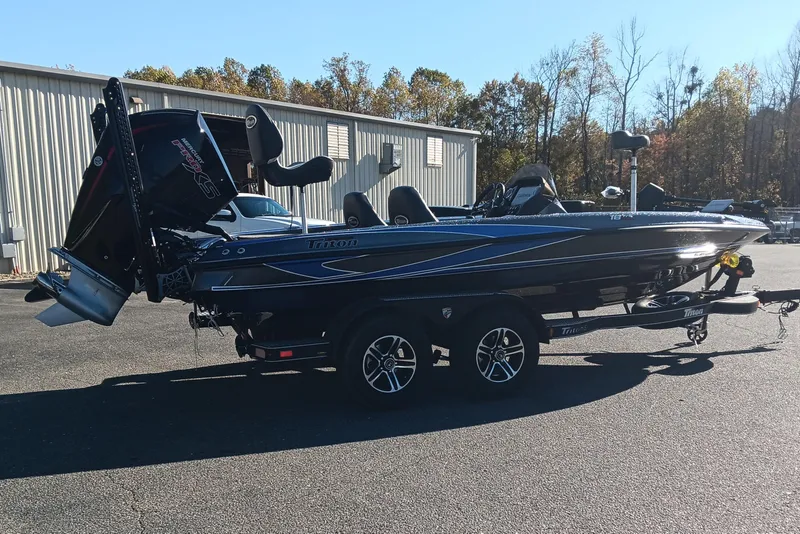 Slide: The Image of 2026 Triton 18 TrX boat rear view with powerful outboard motor on trailer. - 3