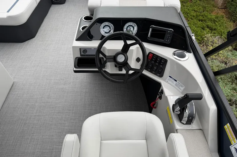 Slide: The Image of 2026 Crest Conquest 210 L boat dashboard with steering wheel and control panel. - 10