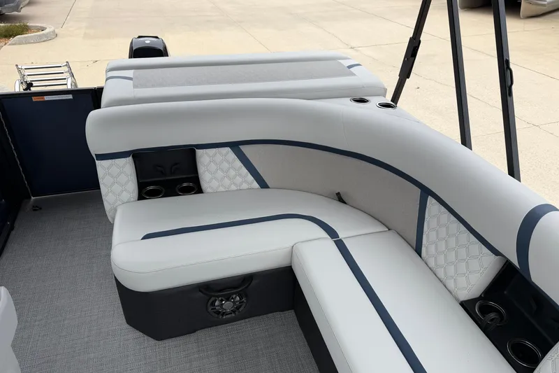 Slide: The Image of 2026 Crest Conquest 210 L boat interior with cushioned seating and cup holders. - 12