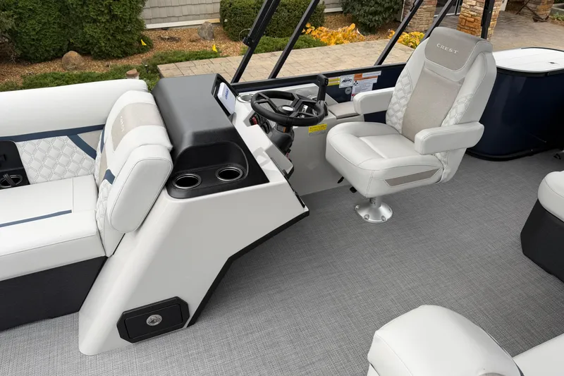 Slide: The Image of 2026 Crest Conquest 210 L boat interior with luxurious seating and modern steering console. - 8