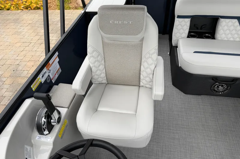 Slide: The Image of 2026 Crest Conquest 210 L boat interior with luxurious seating and control panel. - 9