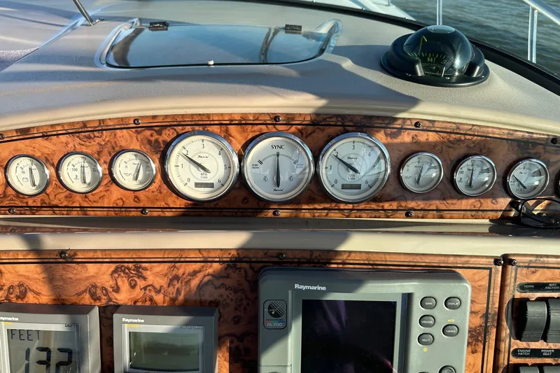 Slide: The Image of Dashboard of a 2004 Larson 370 boat with gauges and navigation equipment. - 12