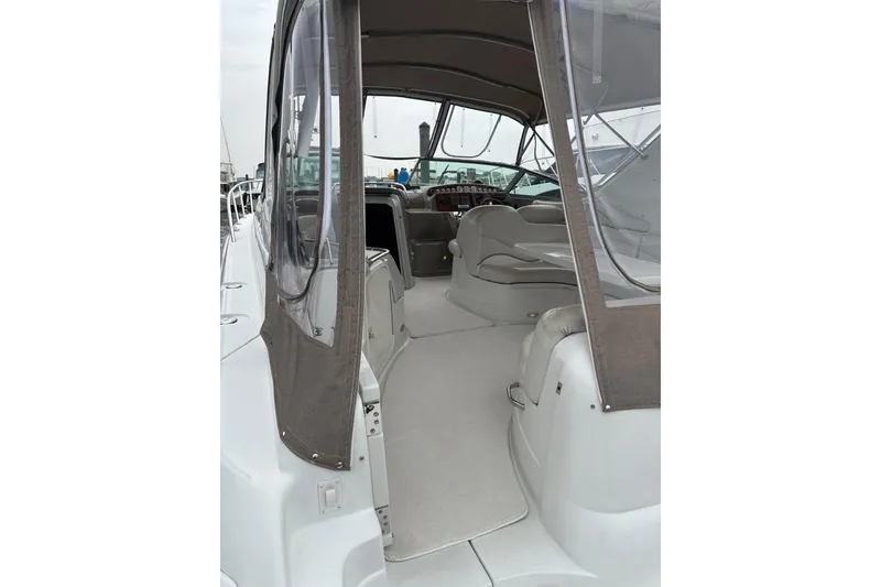 Slide: The Image of 2004 Larson 370 boat interior with seating and dashboard, featuring clear canopy. - 3