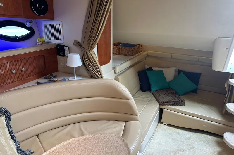 Slide: The Image of Interior of 2004 Larson 370 boat with beige seating, cushions, and wooden accents. - 5