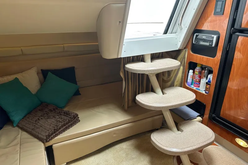 Slide: The Image of Interior of a 2004 Larson 370 boat with cozy seating and storage shelves. - 9