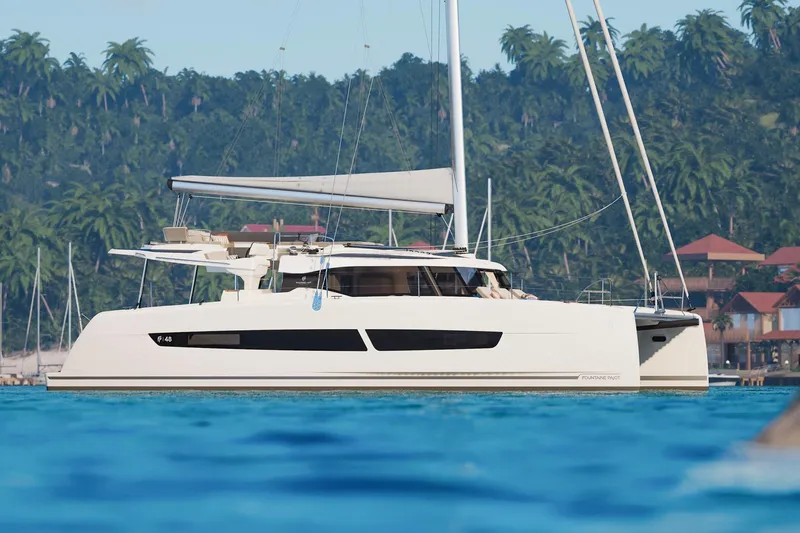 Slide: The Image of 2026 Fountaine Pajot 48 catamaran sailing near tropical coastline with lush greenery. - 36