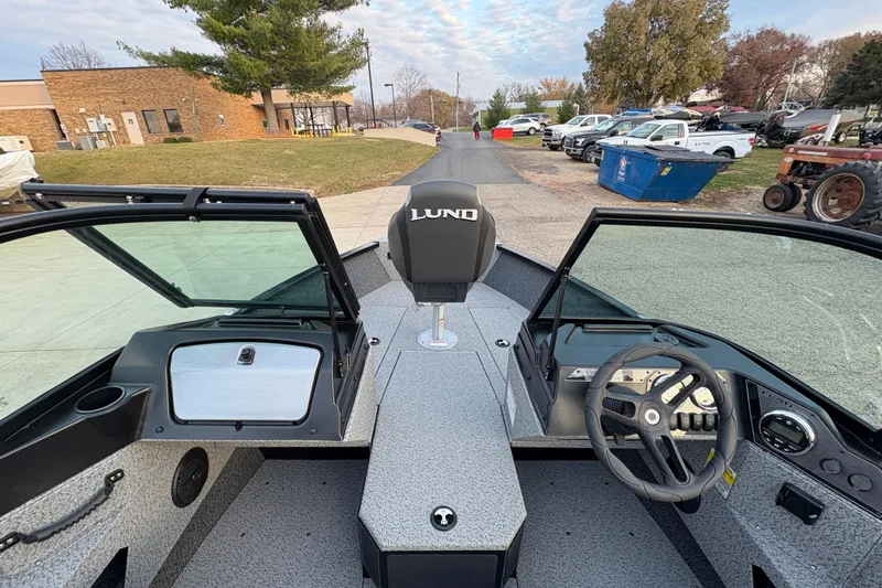 Slide: The Image of 2026 Lund 1775 Adventure Sport boat interior with steering wheel and dashboard view. - 12