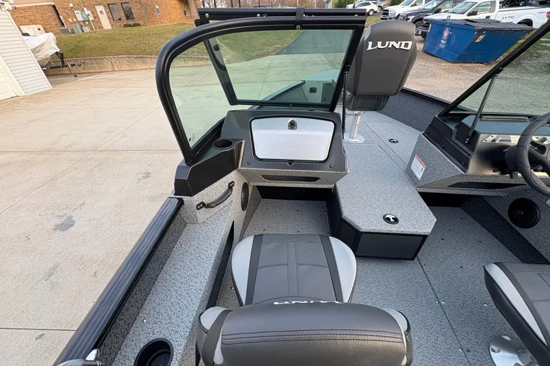 Slide: The Image of 2026 Lund 1775 Adventure Sport boat interior with seating and dashboard view. - 13