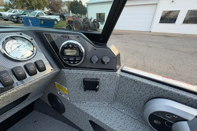 Slide: The Image of 2026 Lund 1775 Adventure Sport dashboard with RPM gauge and control panel. - 17