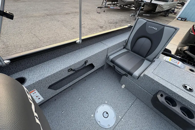 Slide: The Image of 2026 Lund 1775 Adventure Sport boat interior with gray seating and storage compartments. - 19