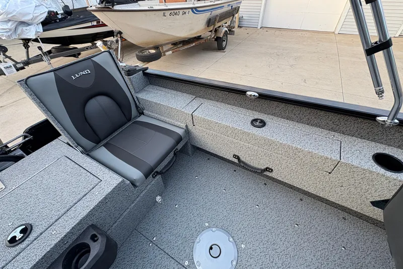 Slide: The Image of 2026 Lund 1775 Adventure Sport boat interior with gray seating and storage compartments. - 22