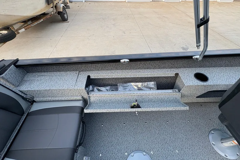 Slide: The Image of 2026 Lund 1775 Adventure Sport boat interior with seating and storage compartments. - 23