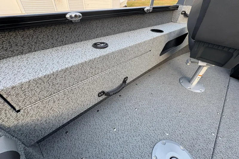 Slide: The Image of 2026 Lund 1775 Adventure Sport boat interior with storage compartment and seating. - 24