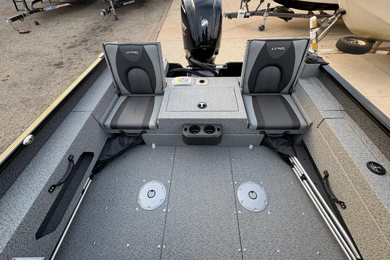 Slide: The Image of 2026 Lund 1775 Adventure Sport boat interior with dual seats and storage compartments. - 26