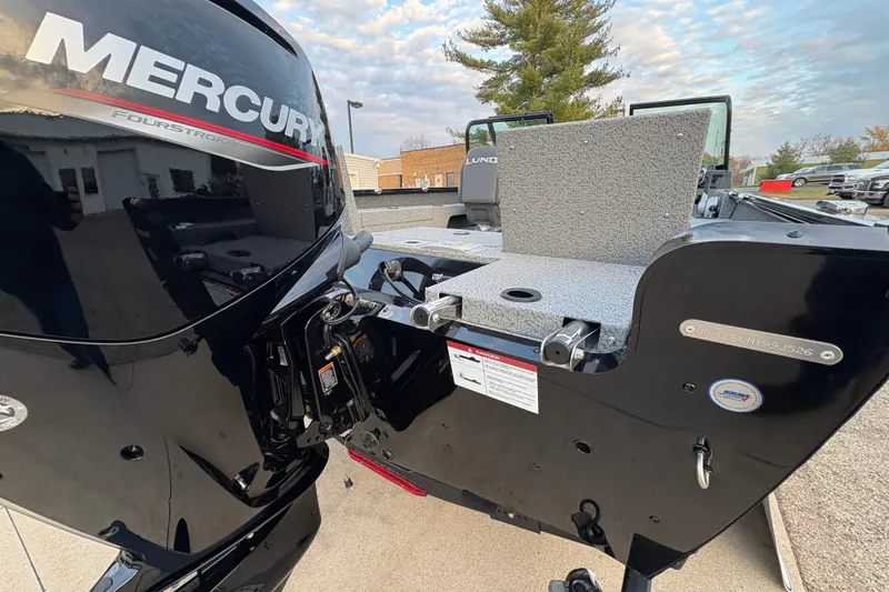 Slide: The Image of 2026 Lund 1775 Adventure Sport boat with Mercury FourStroke engine, outdoor setting. - 27