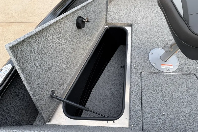 Slide: The Image of 2026 Lund 1775 Adventure Sport boat interior with open storage compartment and seat. - 8