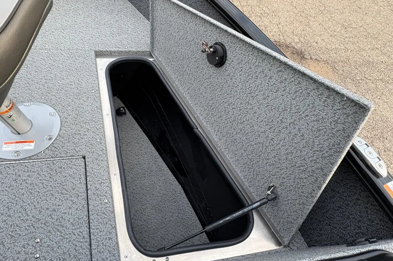 Slide: The Image of 2026 Lund 1775 Adventure Sport boat storage compartment with open lid. - 9