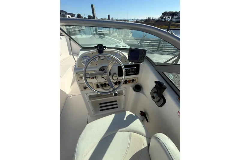 Slide: The Image of 2007 NauticStar 2000 DC Offshore boat cockpit with steering wheel and controls. - 5