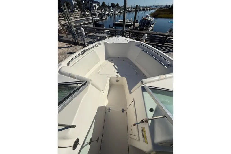 Slide: The Image of 2007 NauticStar 2000 DC Offshore boat interior, docked at marina, showcasing spacious seating area. - 6