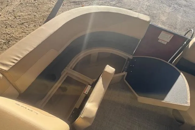 Slide: The Image of 2026 Lowe LS 170 boat interior with tan seating and storage compartments. - 11