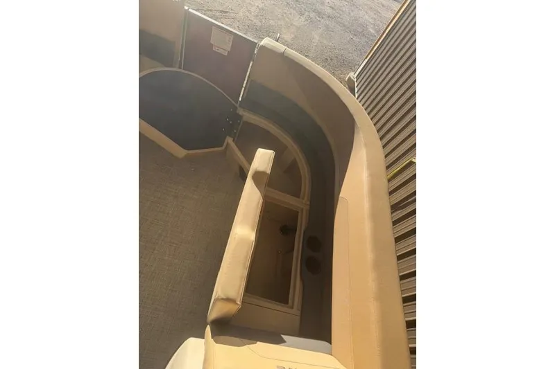 Slide: The Image of 2026 Lowe LS 170 boat interior with beige seating and storage compartments. - 12