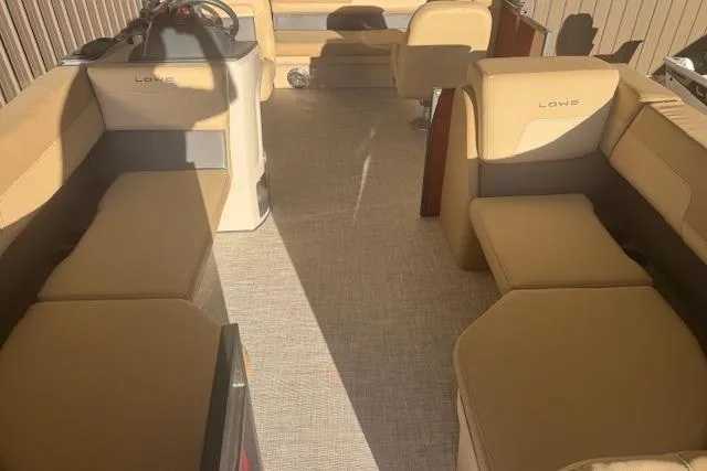 Slide: The Image of 2026 Lowe LS 170 boat interior with beige seating and modern design. - 13