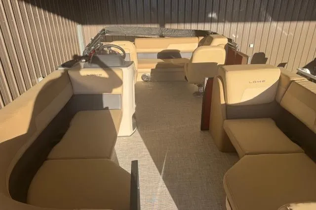 Slide: The Image of 2026 Lowe LS 170 boat interior with beige seating and steering console. - 14