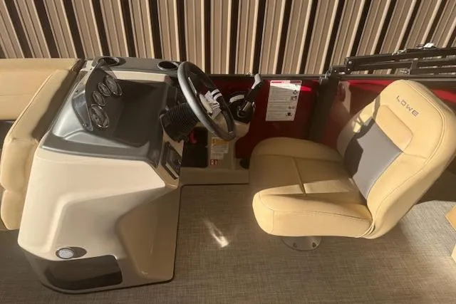 Slide: The Image of Interior of 2026 Lowe LS 170 boat with beige seating and steering console. - 15
