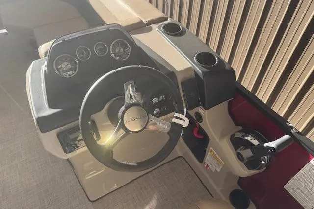Slide: The Image of 2026 Lowe LS 170 boat dashboard with steering wheel and control panel. - 16