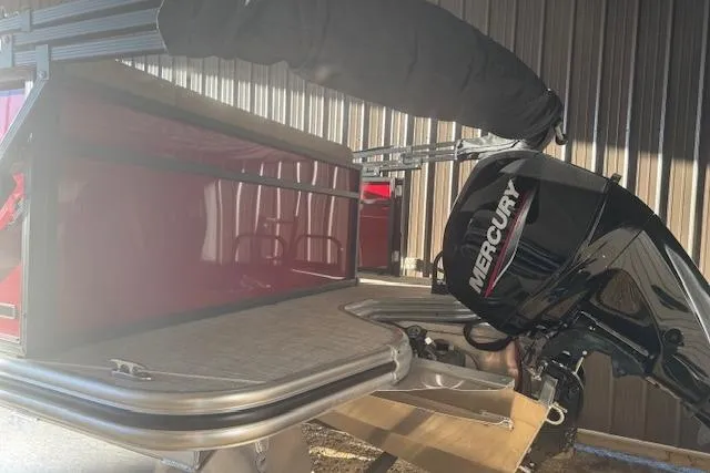 Slide: The Image of 2026 Lowe LS 170 boat with Mercury outboard motor in a storage area. - 6