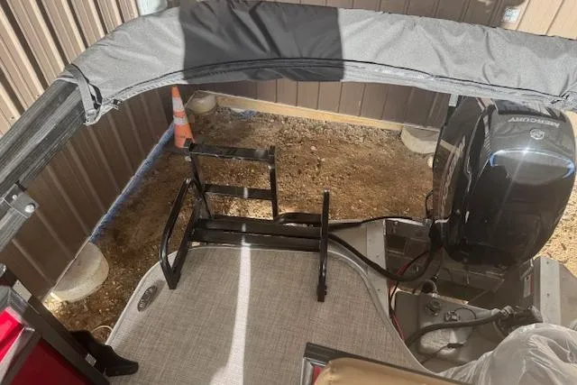 Slide: The Image of Lowe LS 170 boat interior with Mercury engine, 2026 model, in a storage area. - 8