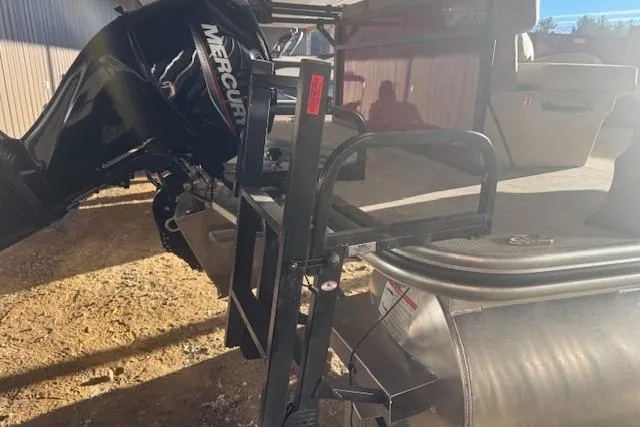 Slide: The Image of 2026 Lowe LS 170 boat with Mercury outboard motor and ladder in sunlight. - 9