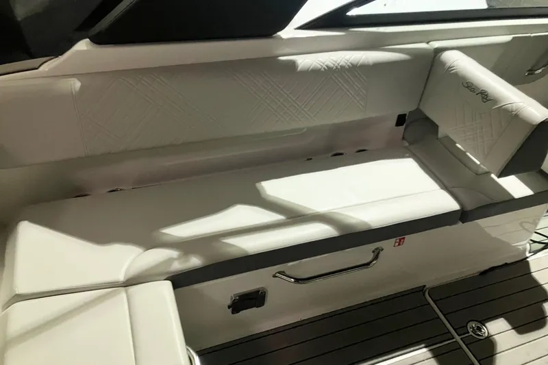 Slide: The Image of 2025 Sea Ray SDX 270 Outboard interior seating with elegant white upholstery and modern design. - 11