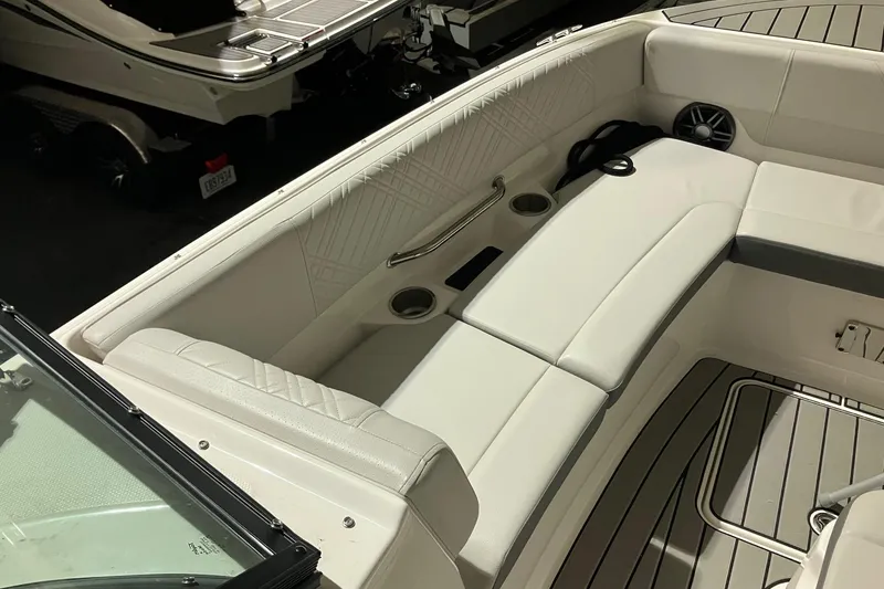 Slide: The Image of 2025 Sea Ray SDX 270 Outboard interior with white seating and cup holders. - 18