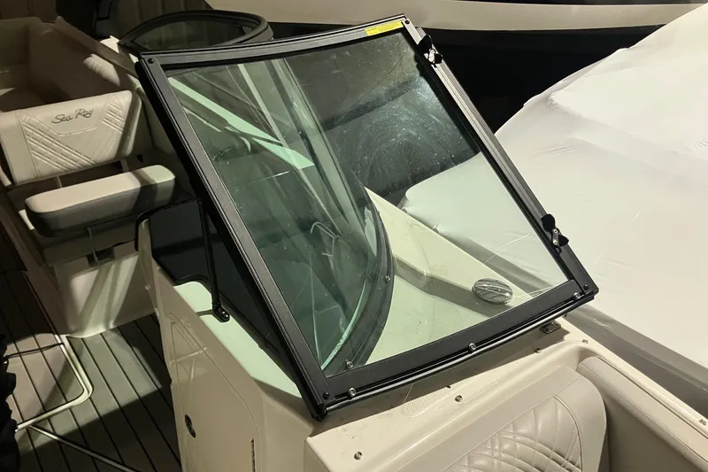 Slide: The Image of 2025 Sea Ray SDX 270 Outboard boat interior with windshield and seating. - 20