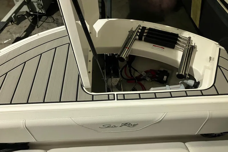 Slide: The Image of 2025 Sea Ray SDX 270 Outboard boat storage compartment with hydraulic lift and wiring. - 22