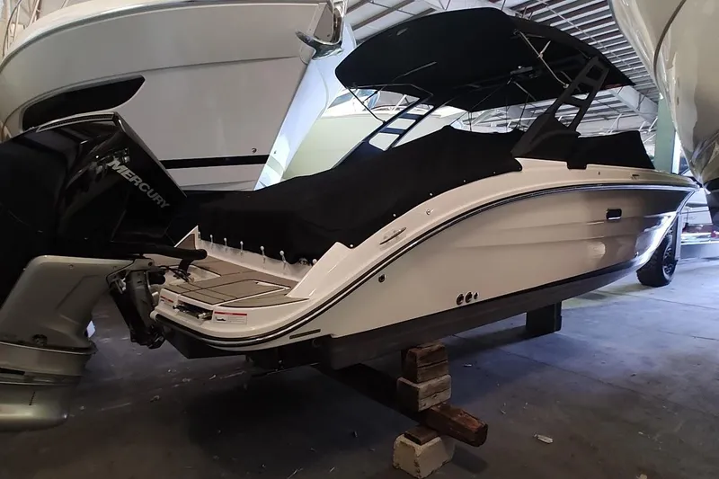 Slide: The Image of 2025 Sea Ray SDX 270 Outboard boat in storage, covered and elevated on blocks. - 4