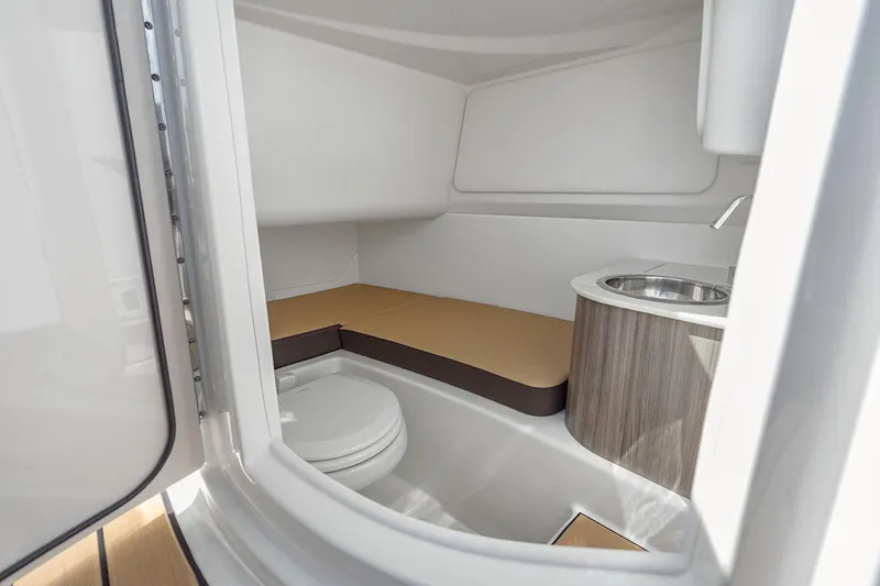 Slide: The Image of 2025 Sea Ray SDX 270 Outboard interior seating with elegant gray upholstery and sleek design. - 9