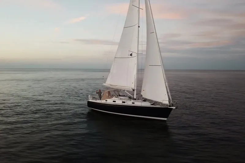 The Image of Sailing yacht Tartan 345, 2018 model, cruising on calm ocean waters at sunset. - 0