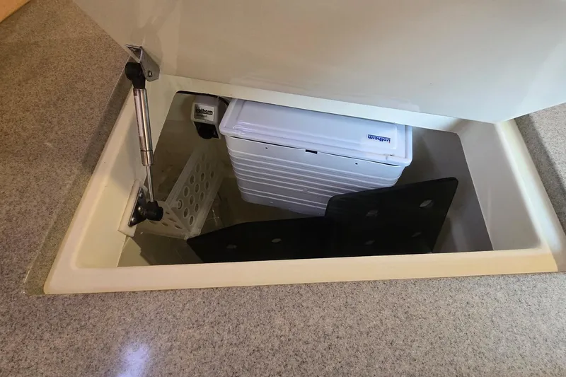 Slide: The Image of Storage compartment in a 2018 Tartan 345 yacht, featuring organized interior space. - 11