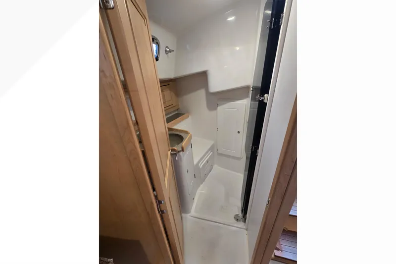 Slide: The Image of 2018 Tartan 345 yacht interior bathroom with wooden cabinetry and compact design. - 15